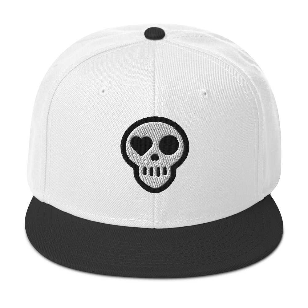A Black / White / White hats_ghost snap from Phobea with a heart eye skull logo