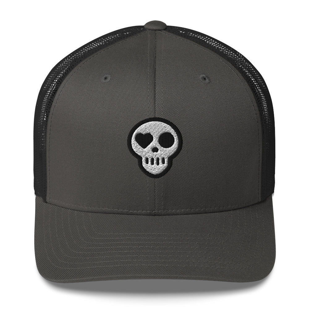 A Charcoal Hats - Nomad Trucker from Phobea with a heart eye skull logo